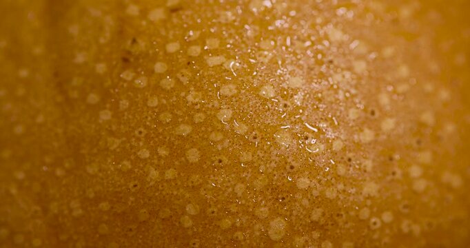 The dense peel of the pear is yellow in color, the natural peel of the pear has a rough texture with small depressions and granular spots.