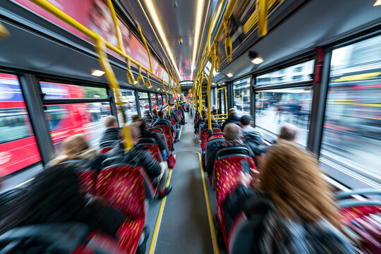 Commuters on double decker bus, business motion concept