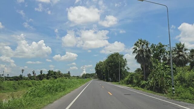 Driving on country road in rural, Singburi province Thailand.
