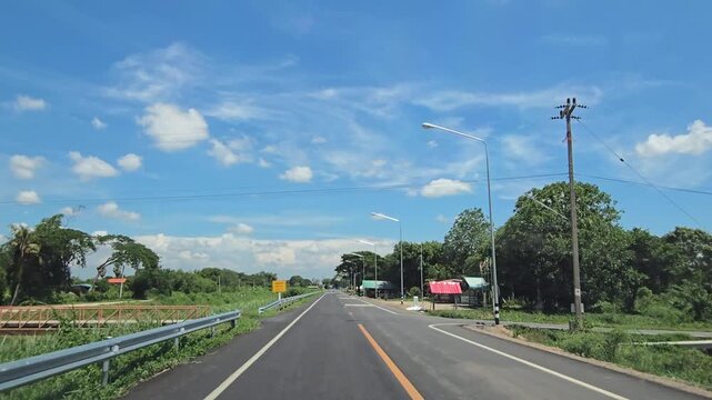 Driving on country road in rural, Singburi province Thailand.