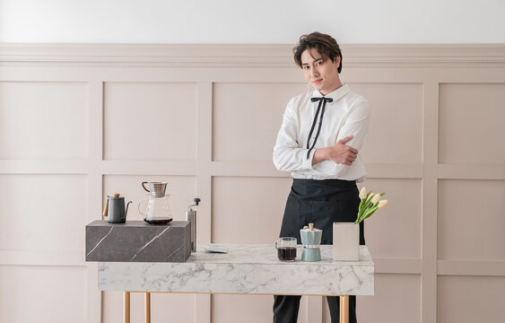 Startup successful small business owner man sme, handsome men sit in coffee shop restaurant. Portrait of young relax asian man barista cafe local owner. SME sell online entrepreneur business