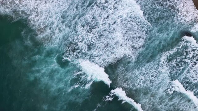 Top Down Aerial Drone View of Turquoise Ocean Waves Crashing along California Coast