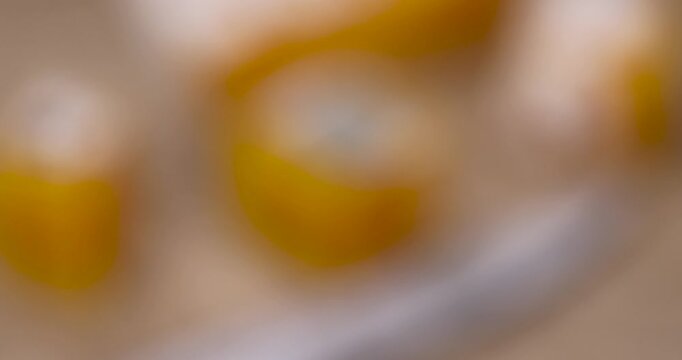 Hard yellow cheese with mold, the product cheese with mold and mildew on the surface lies on brown paper in the side lighting.