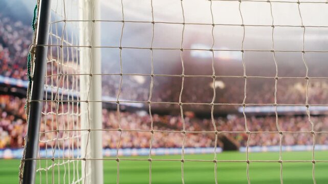 Angled soccer goal net and side post framing empty pitch with blurred stands and bright stadium light, football match on pitch, goal frame and post, for stadium football match content.