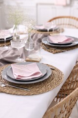 Fototapeta premium Beautiful place setting with floral decor on table in dining room, closeup