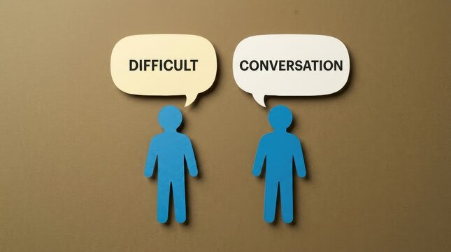Two blue paper people standing with speech bubbles displaying the text difficult conversation against brown