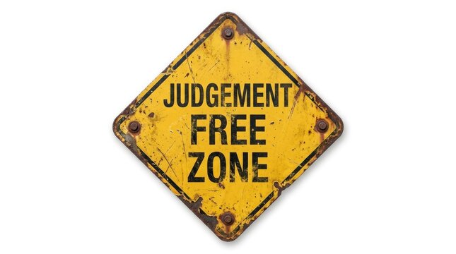 Weathered yellow diamond shaped metal sign displaying the text judgement free zone against white background