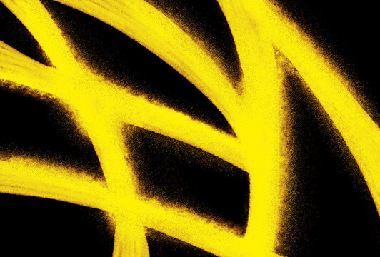 Abstract bright yellow spray paint strokes and graffiti lines on black background