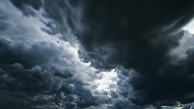 Dramatic Sky with Dark Storm Clouds and Light Breaking Through.