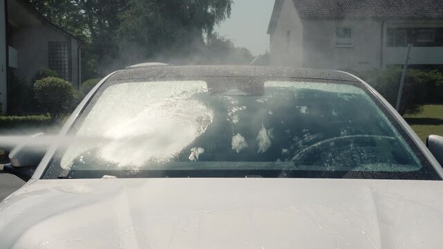 Manual wash with foam. Hands washing car during auto detailing. Car wash. Car in washing process. Carwash station. Hand washing spraying in garage. Professional car valeting