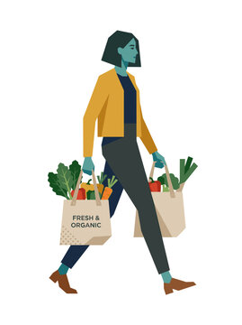 Woman Walking with Bags of Fresh Organic Produce