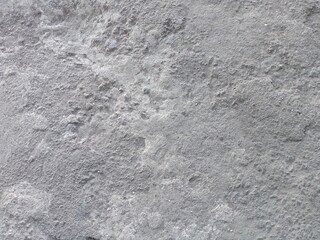 Fototapeta premium Rough and weathered gray concrete surface texture, grainy cement wall or floor background, high-angle close-up view.