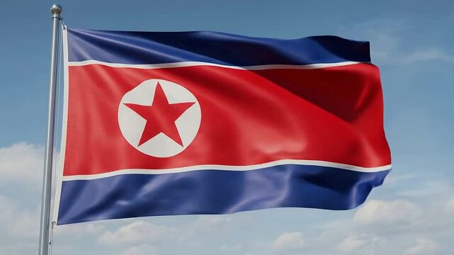 North Korean Flag Waving in the Wind Against Blue Sky