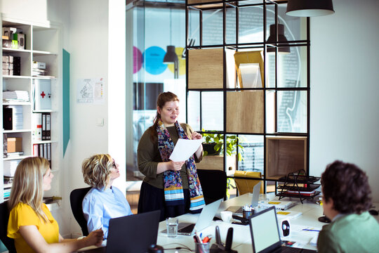 Businesswoman leading team meeting in modern office