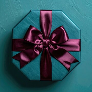 Teal octagonal gift box with rich maroon satin ribbon and bow