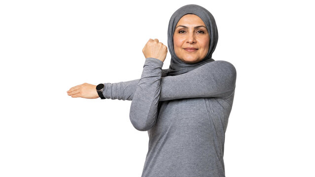 Active Mature Muslim Woman in Hijab Stretching Arms During Fitness Workout Isolated