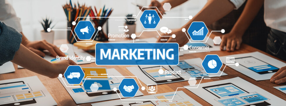 A vibrant marketing strategy development session highlighting collaboration among team members using charts and visuals on a wooden table, aimed at enhancing brand identity and product outreach. Amity