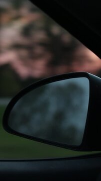 rear view mirror at sunset on the highway