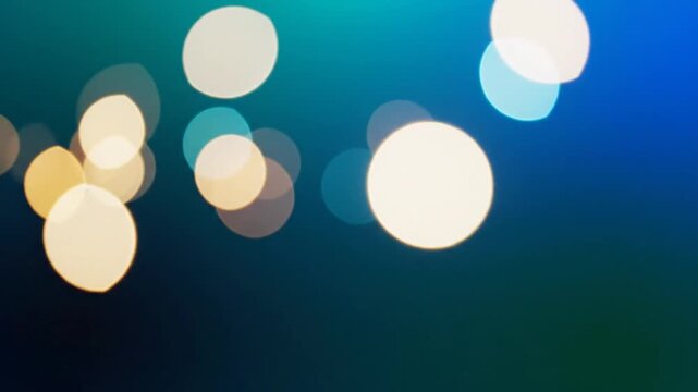 Golden bokeh lights on dark blue gradient background