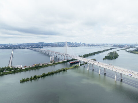 Aerial view of Brossard suburban Montreal skyline beyond the river and bridge. g