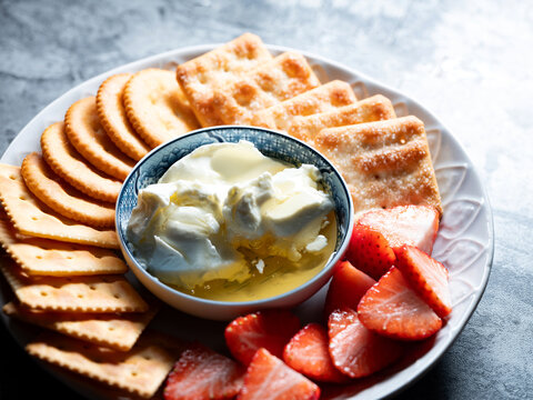 A plate of cheese and fruit