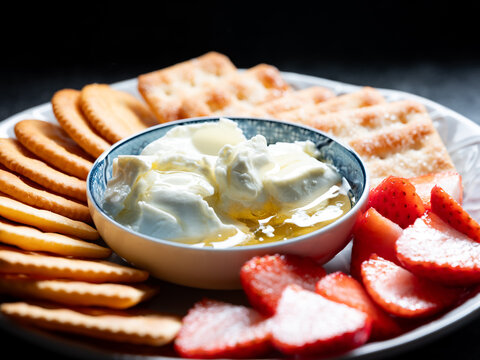 A plate of cheese and fruit