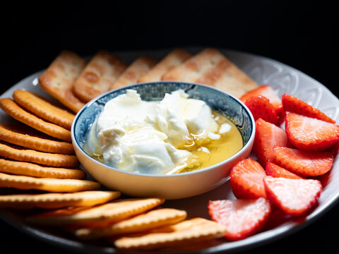 A plate of cheese and fruit