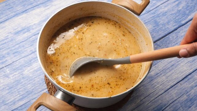 Cooking a simple soup in a kitchen with a blue table