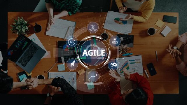 Diverse professionals collaborate in an office setting, discussing agile methodologies while analyzing data and developing strategies for project success. Raster