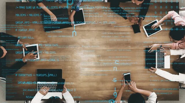 Aerial view of a diverse team engaged in a collaborative strategy meeting, utilizing digital devices while surrounded by coding and data streams to spark innovation. Xenic