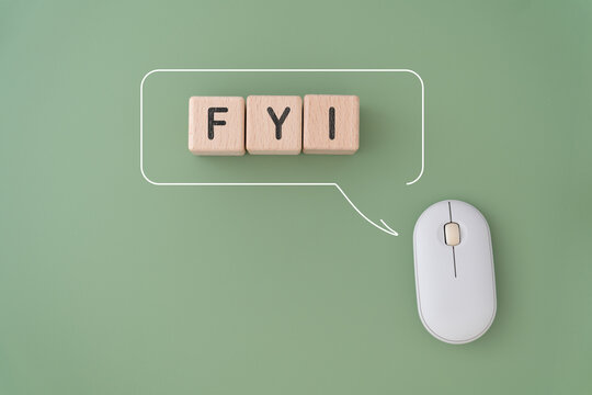 FYI , for your information, text on wooden cube block inside speech bubble with white computer mouse on green background