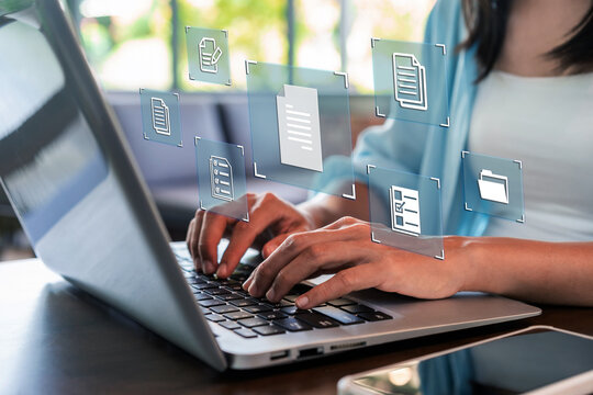 Cropped shot of a female professional managing digital files and cloud storage on a laptop computer.