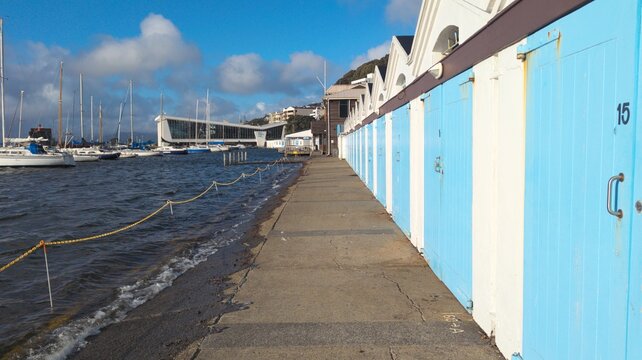 Scenic view of iconic boat sheds with painted blue doors in harbour marina capital city of Wellington, New Zealand Aotearoa