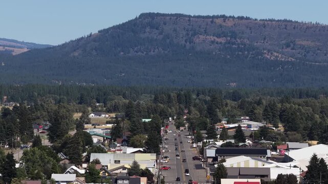 Aerial of Cle Elum Washington town street with mountain backdrop in summer