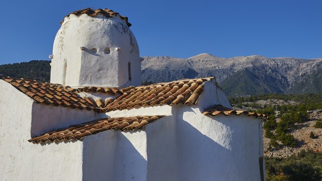 Church of St Michael the Archangel, Cross-domed church, Bright sunshine on a traditional church with a view of the mountain landscape, Aradena Gorge, Aradena, Sfakia, Crete, Greece