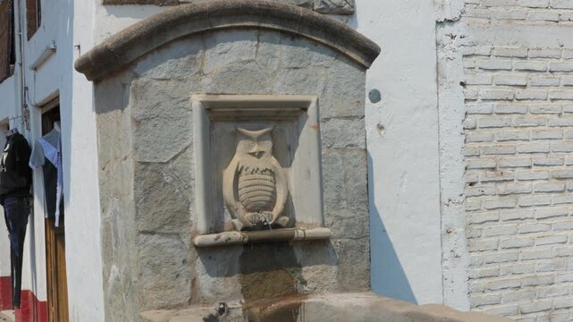 Pila del Tecolote fountain with blue tiles and an owl sculpture in Tapalpa, Jalisco, Mexico