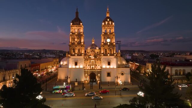 A striking, high-contrast twilight portrait of the historic Cathedral Basilica of Durango illuminated against the evening sky.