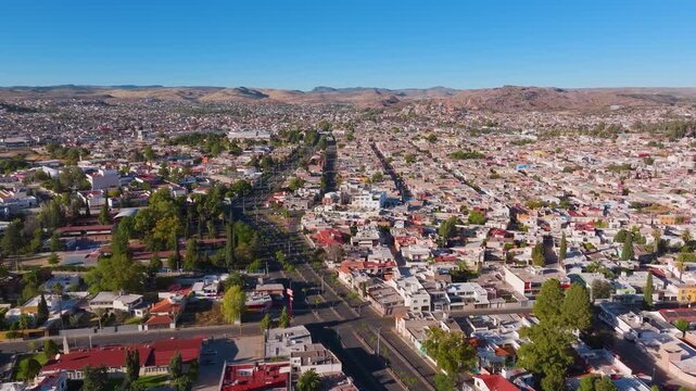 A sweeping aerial perspective documenting the expansive urban layout of Victoria de Durango during a bright, clear afternoon.