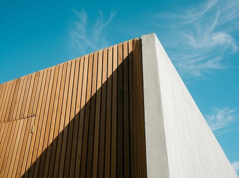Modern Architectural Facade with Wood and Concrete Under Blue Sky