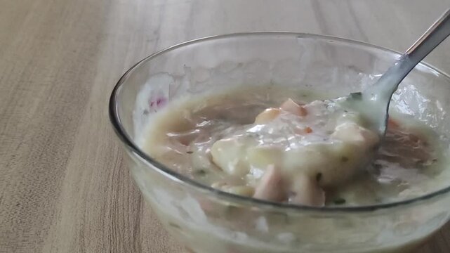 Creamy Homemade Vegetable Soup with Spoon in Glass Bowl