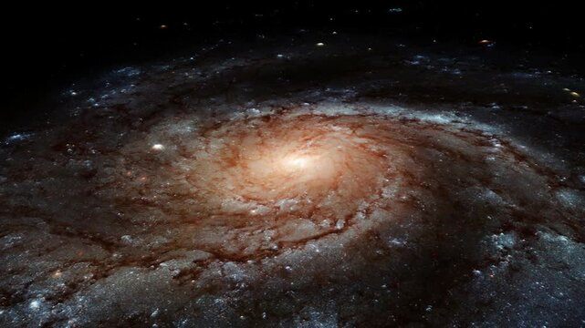 The glowing core of a distant spinning spiral galaxy in outer space.