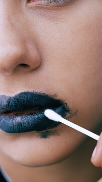 Lower face close up black lipstick removal on sensitive skin cotton swab cleaning makeup natural skin tone soft light macro portrait smooth skin clean background selective focus