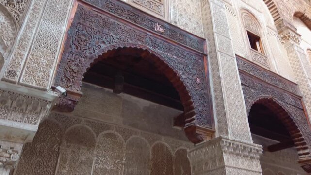 Al Attarine Madrasa in Fes El Bali, Morocco, with ornate zellige tile work, stucco, cedar wood carvings, geometric patterns and Arabic calligraphy in the historic medina.