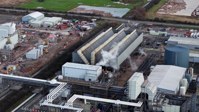 Aerial view of rows of massive air-cooled condensers spinning at a large gas-fired power station in Immingham, Lincolnshire, UK.