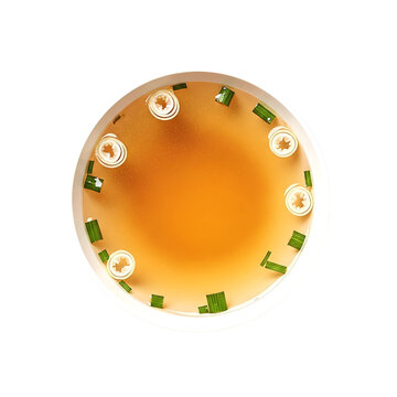 Clear glass bowl of beef consomme on transparent background