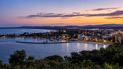 Naklejka premium Peaceful Australian Coastal Town Harbor Glowing Beneath Colorful Dusk Sky