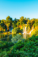 Kravice Waterfalls on the Trebižat River, a natural amphitheater of cascading water and lush green nature near Ljubuški, Bosnia and Herzegovina. © Zedspider
