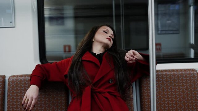 A stylish brunette in a scarlet coat riding a subway car, city rhythm