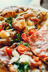 Texture of cooked pizza with ham, cheese and tomatoes. © Cavan
