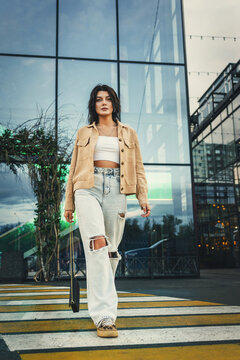 Stylish woman walking on a pedestrian crossing